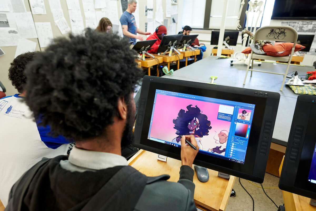 Student drawing an animation on a digital tablet in a classroom