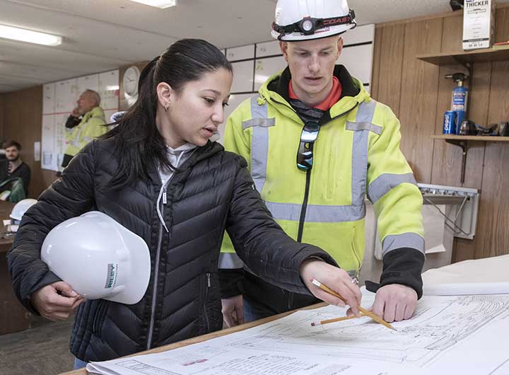Architect discussing plans with construction worker