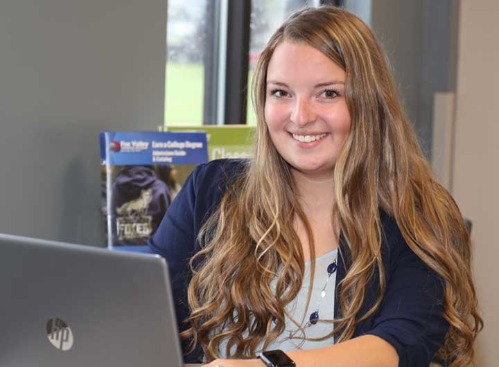 Woman working on laptop smiling