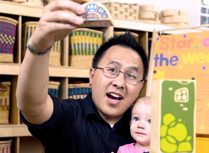 Teacher in classroom with young child