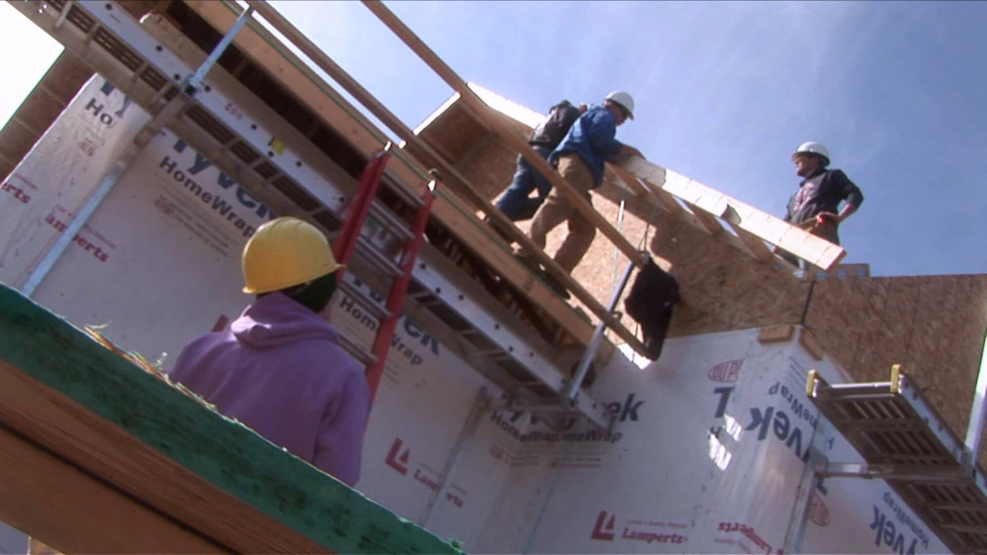 workers constructing a house 