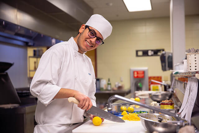 Culinary production specialist working to prepare meals