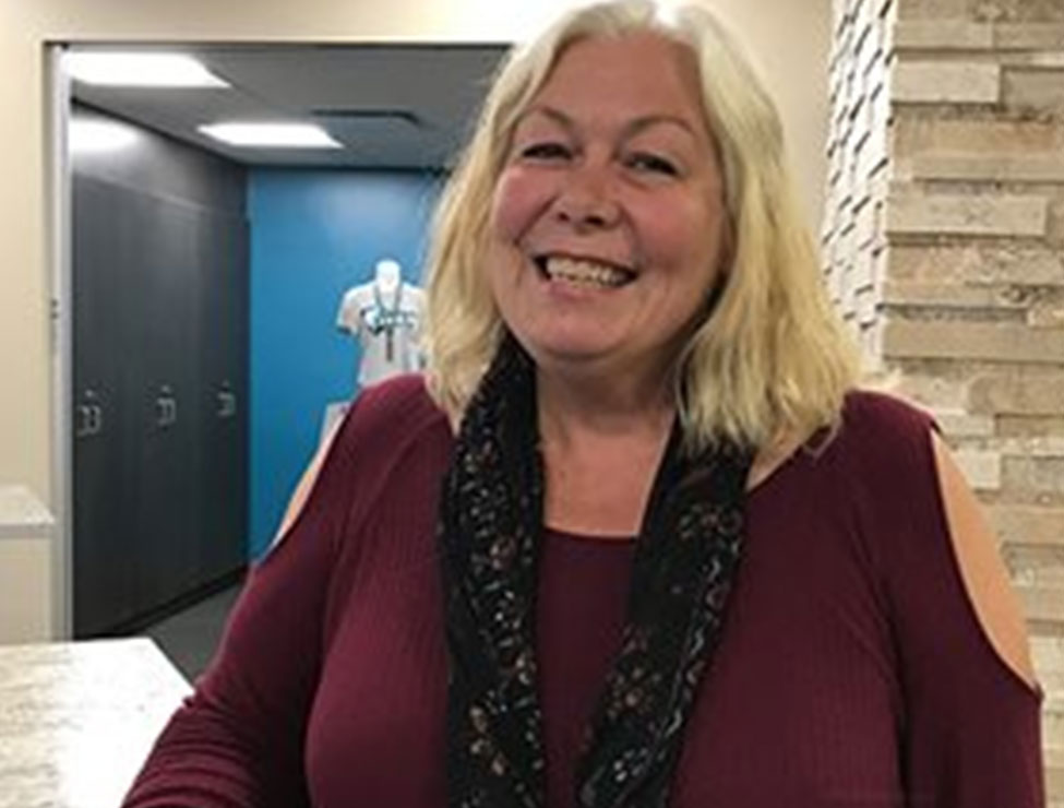 Faculty member smiling in campus building