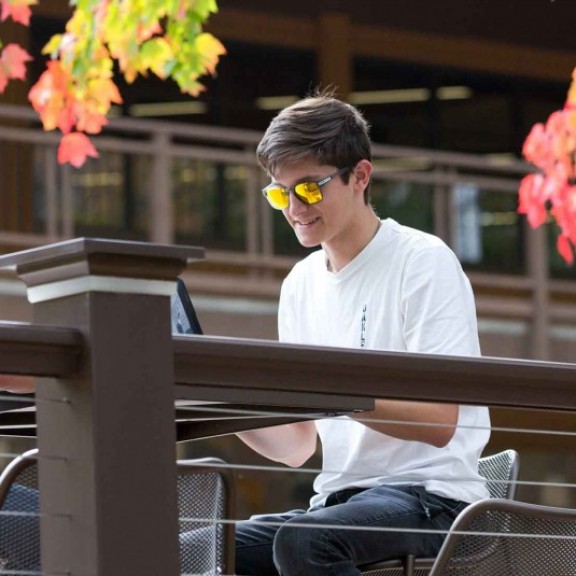 Students studying on campus picnic table