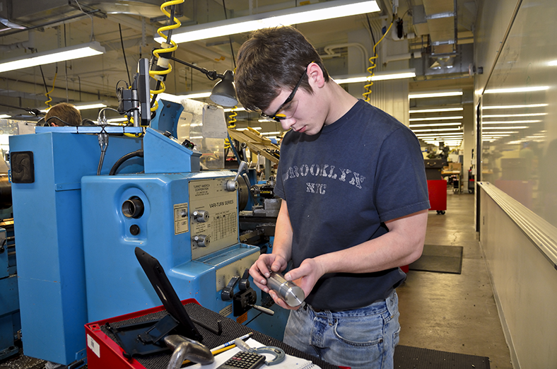 Precision Machinist inspecting a lathe