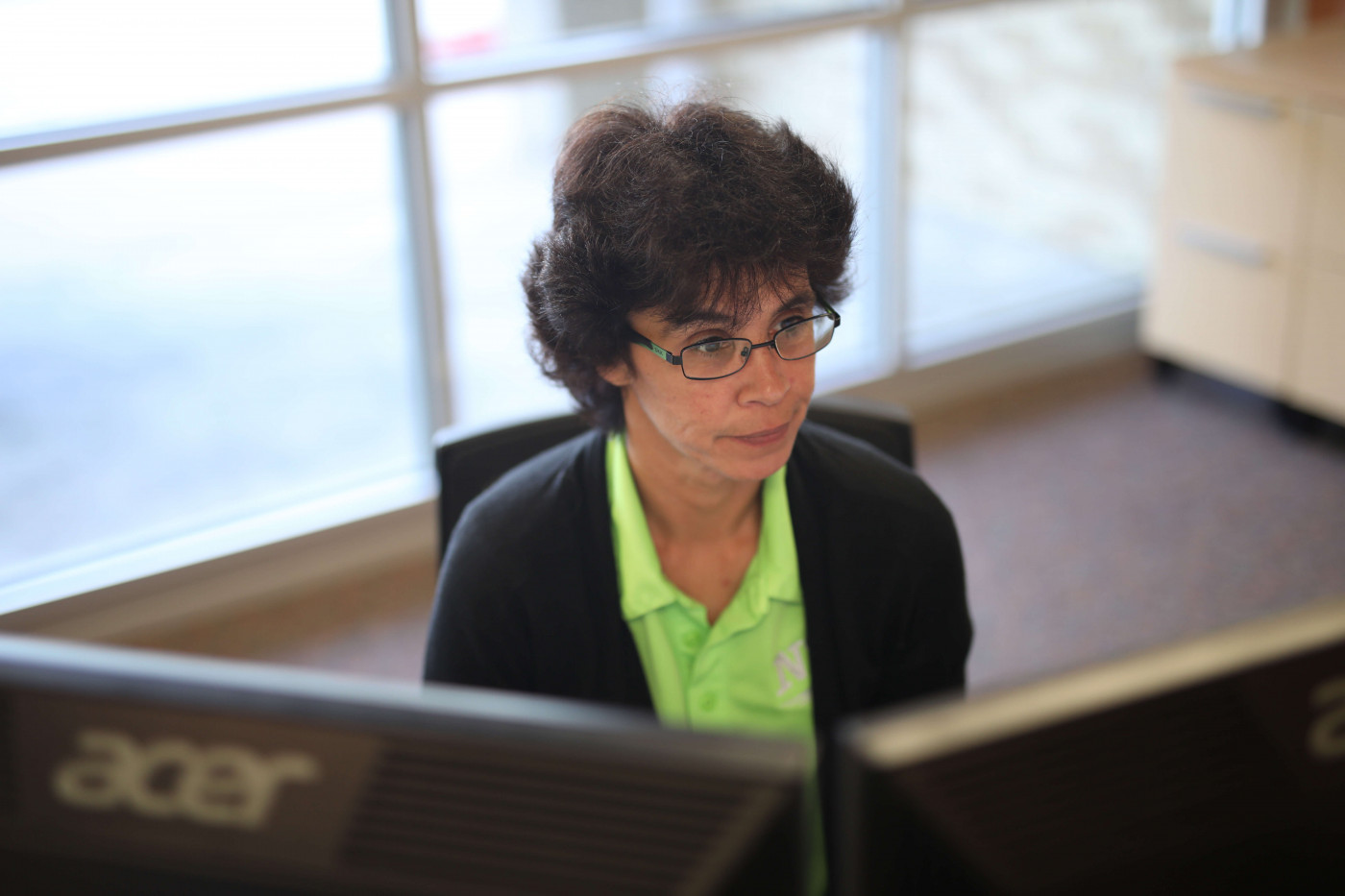 Woman working on dual screens