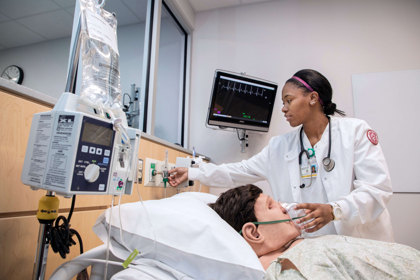 Nursing student working with simulated patient