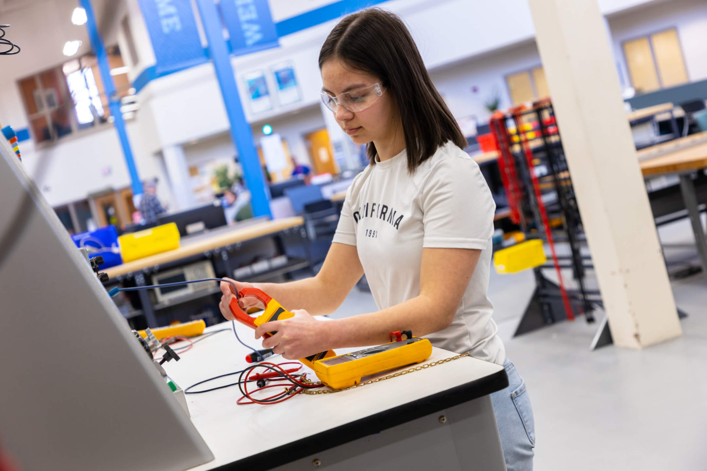 student working on electronics board in industrial mechanic lab