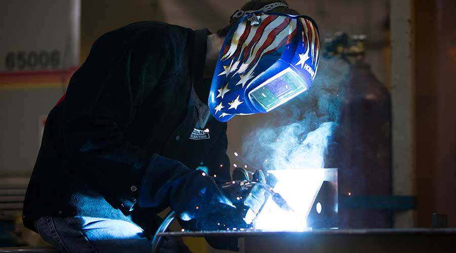 Welding student actively working on project