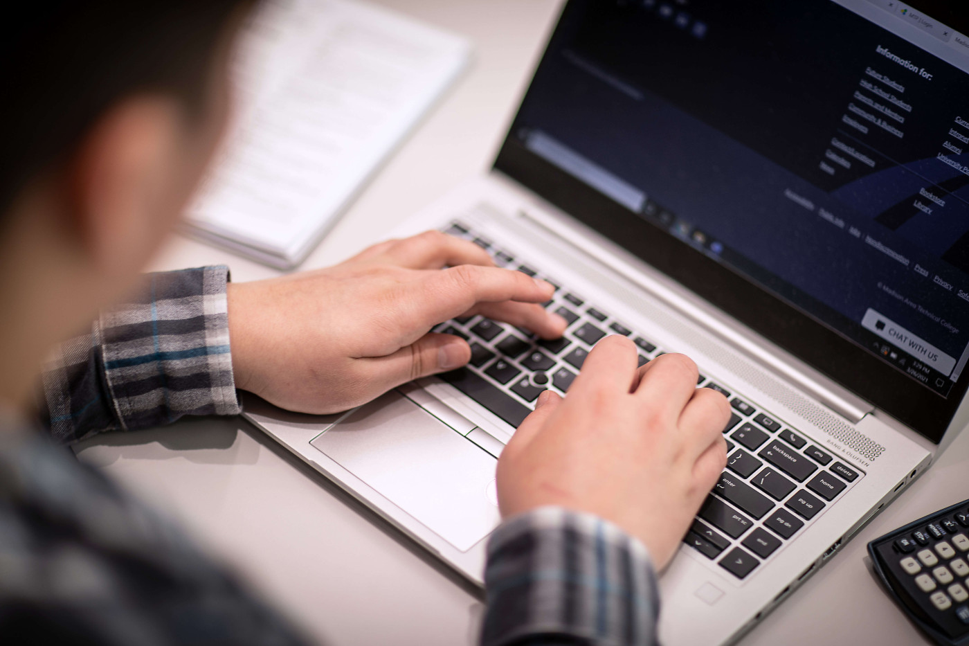 Student completing an assignment on a laptop