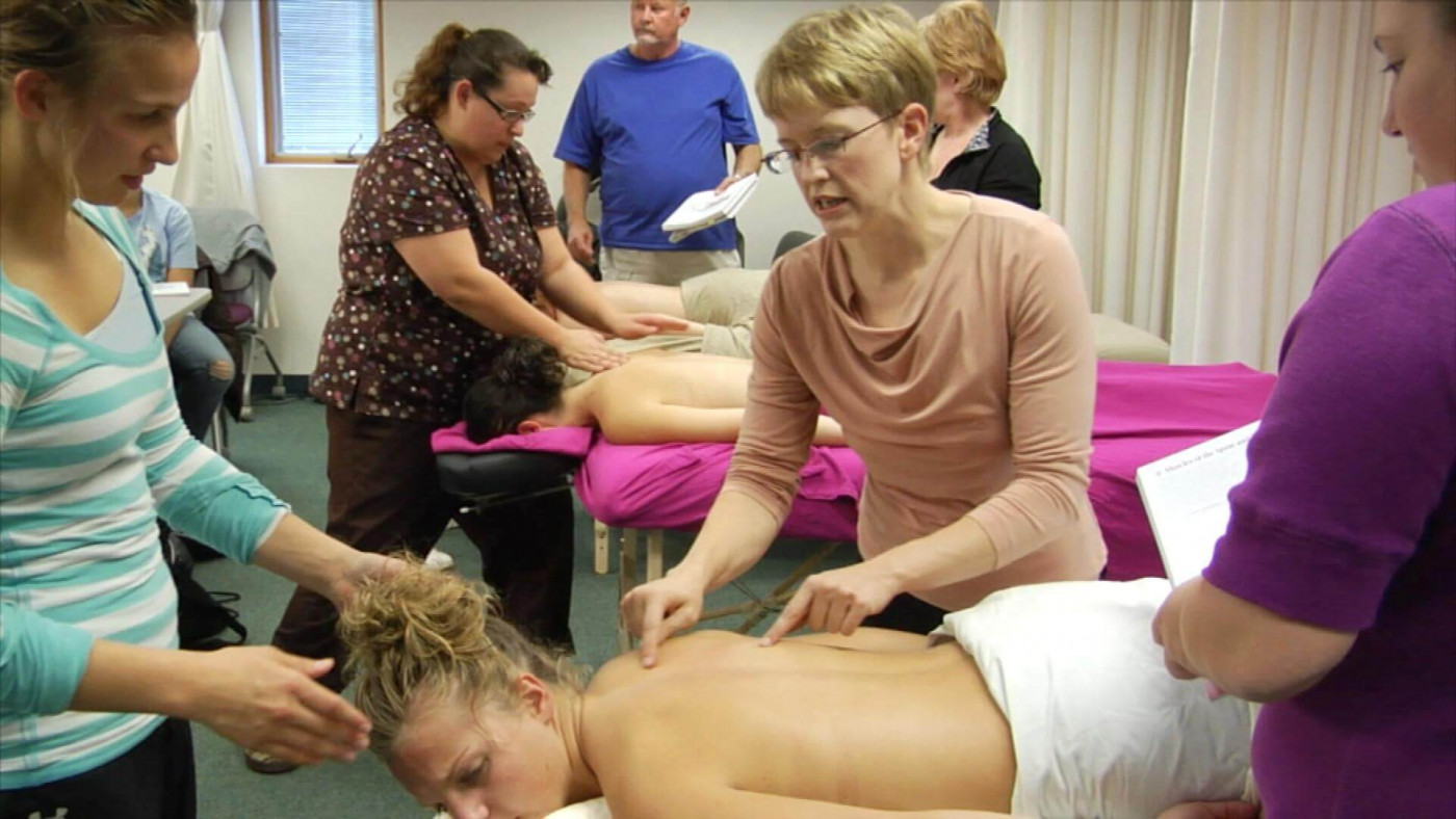 Students learning about techniques with massage therapy